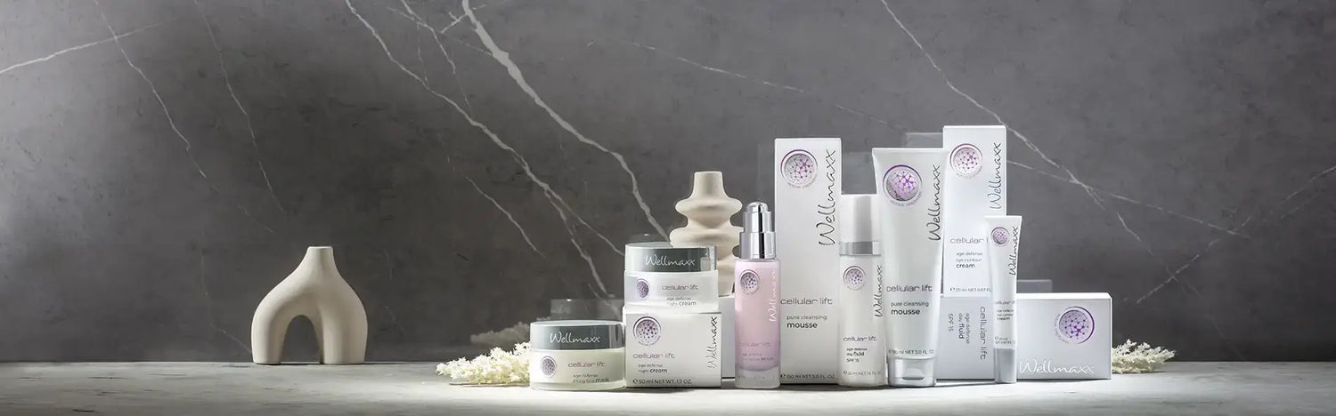A collection of skincare products arranged on a stone surface against a marble background, showcasing beauty essentials.