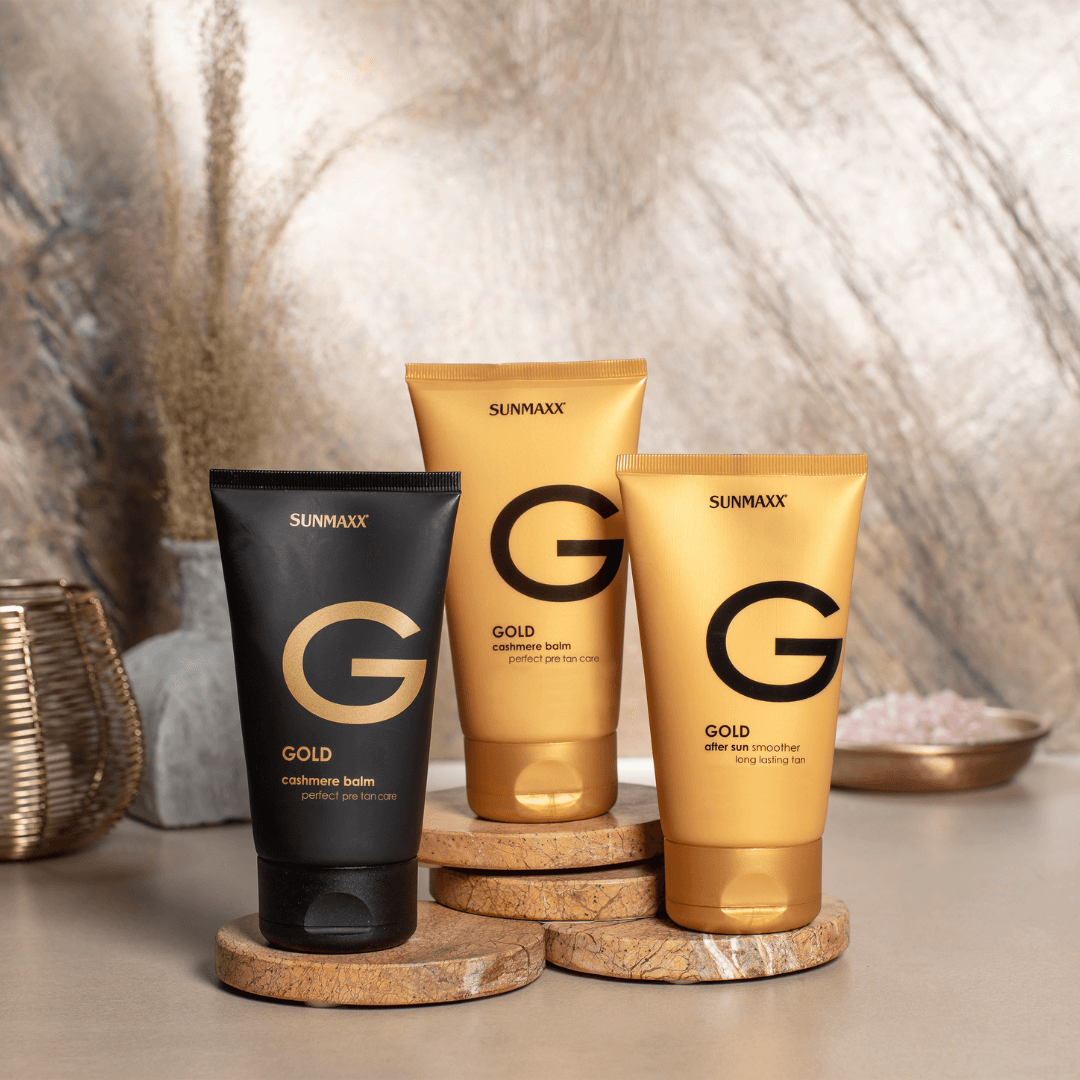 GOLD After Sun and balm products by SUNMAXX displayed on a textured surface, designed for skin care and after-sun relief.