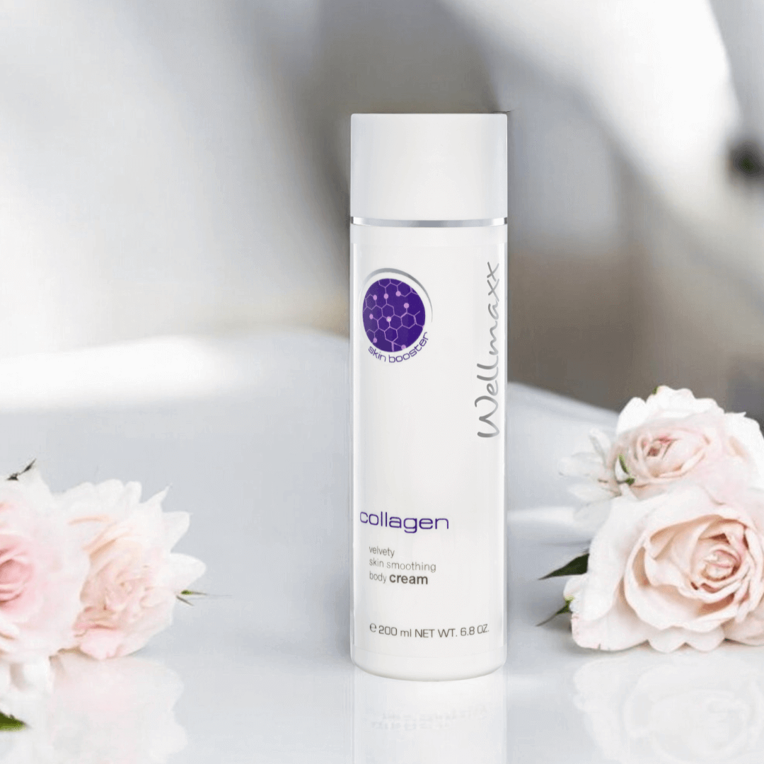 Wellmaxx collagen velvety skin smoothing body cream beside pink roses on a white surface.