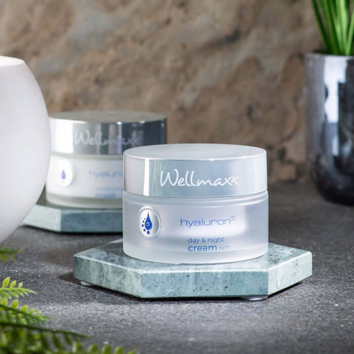 Wellmaxx hyaluron⁵ day and night cream rich on a marble surface, promoting radiant and smooth skin.