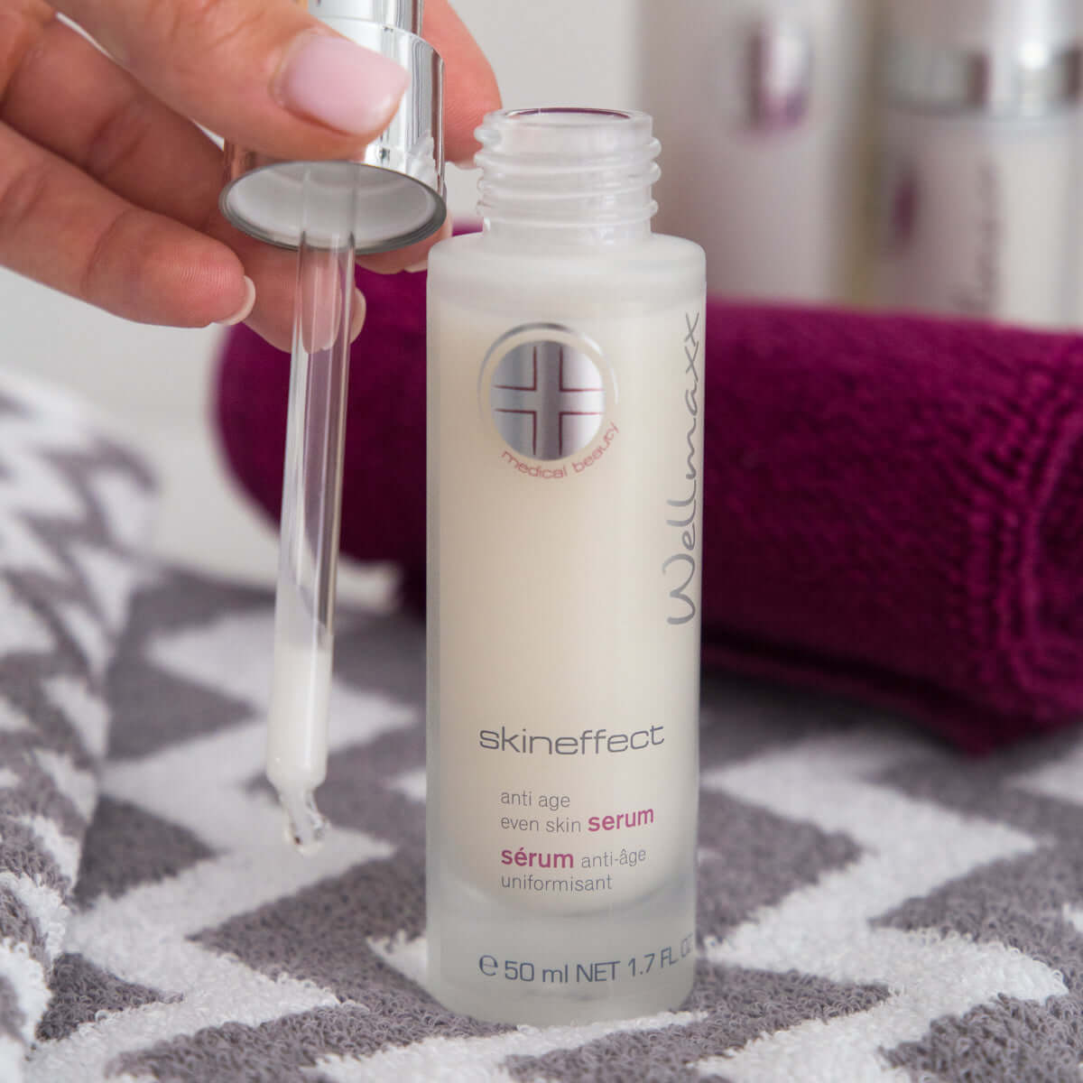 WELLMAXX Skineffect Anti Age Even Skin Serum in a bottle with dropper for hydrating dry skin and reducing wrinkles.