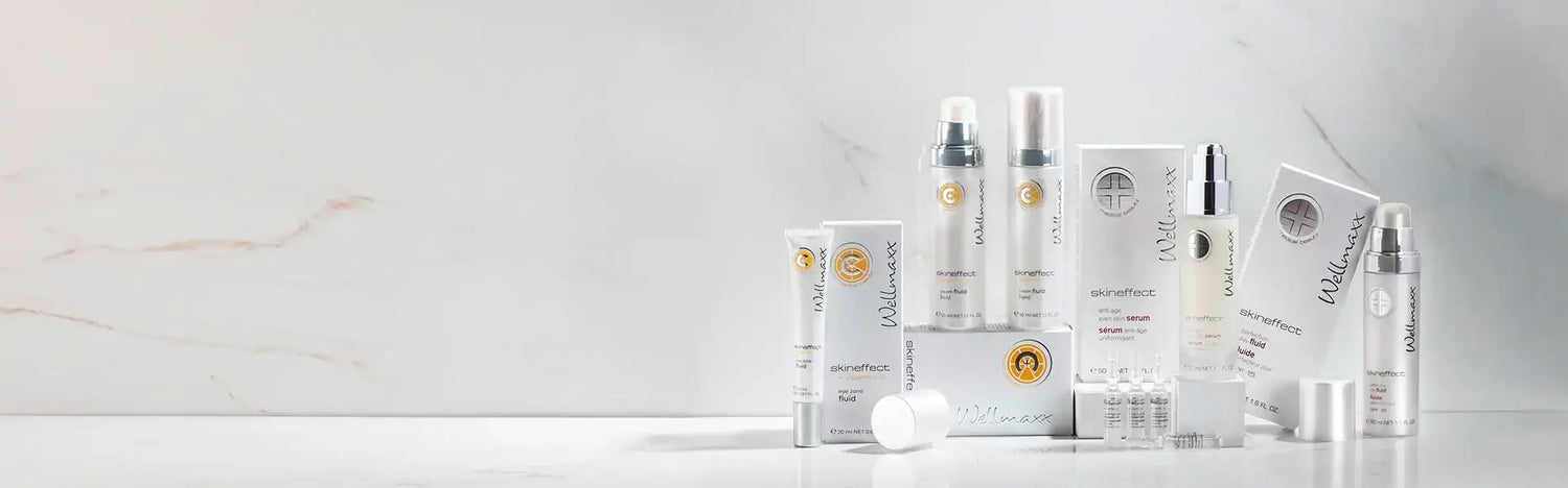 Collection of skincare products in elegant packaging on a marble countertop, showcasing beauty essentials.