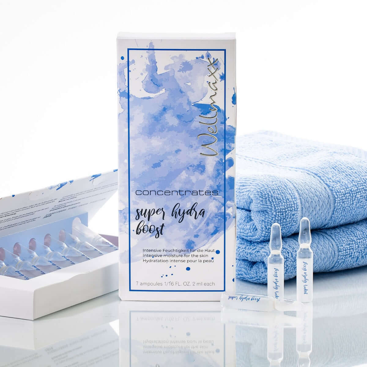 Wellmaxx super hydra boost ampoules in packaging with soft towels, highlighting intense skin hydration and anti-aging benefits.