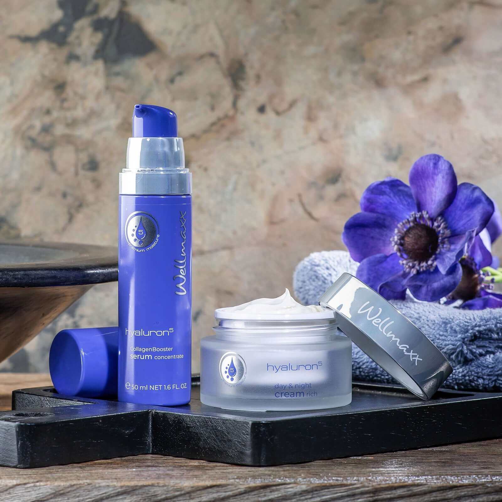 Wellmaxx skincare products featuring hyaluron serum and cream set on a wooden display.
